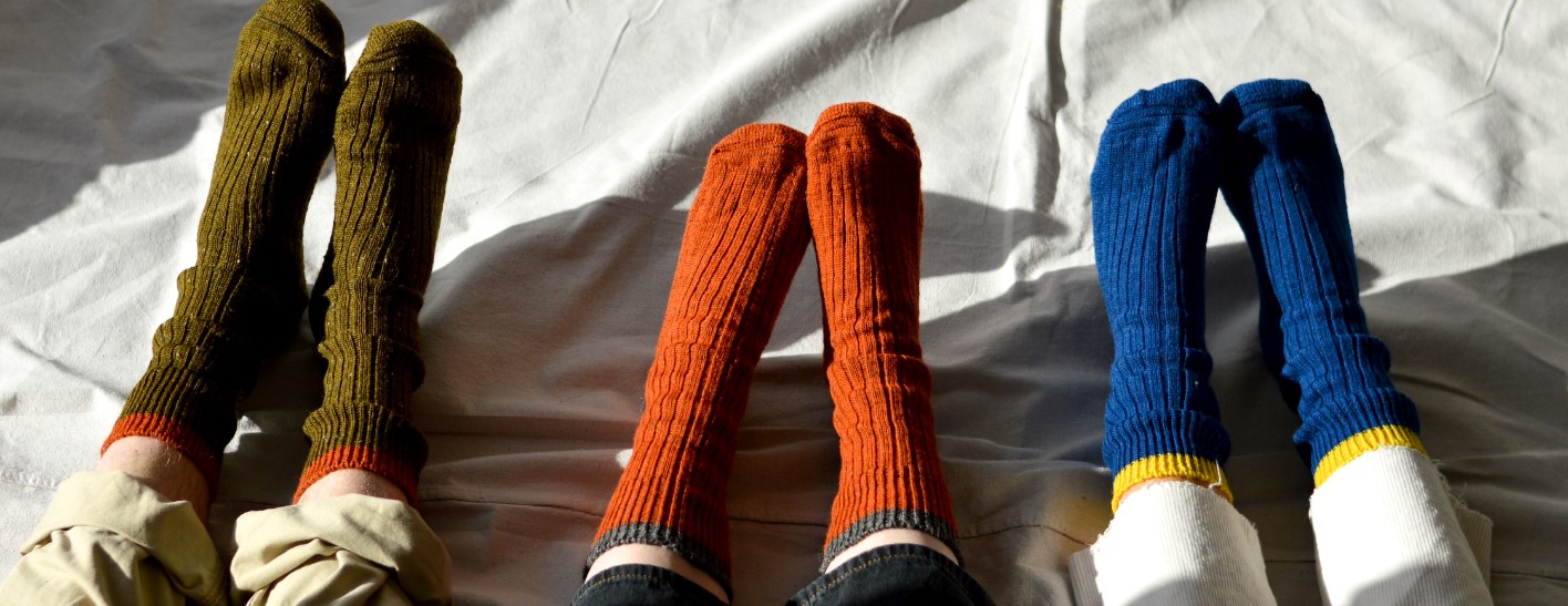 An example photograph from Bitter Lemon for our client Peregrine, 3 sets of socks on feet, looking very aesthetic